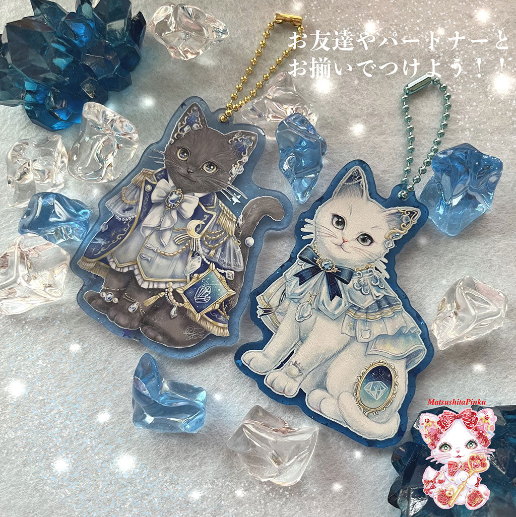 たくさんの星降る世界と光知る僕の特別な結びつき（アクリルキーホルダー）光を追いかけ、動く勇気を固める猫ver.／イラストレーター松下ピンク